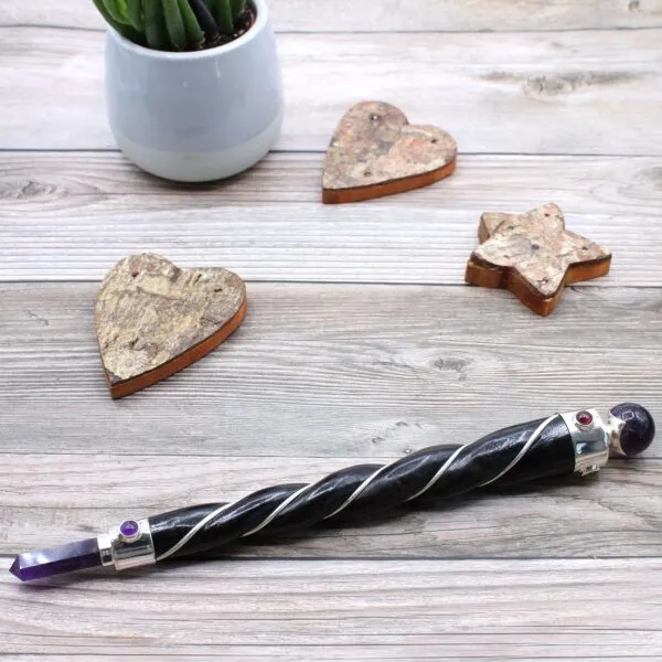 Twisted Magic Wand - Wooden Silver Wire Red Gemstone Twisted wooden magic wand wrapped with silver wire and featuring a red gemstone.
