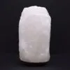 Himalayan Salt Lamp Rock Crystal White Dark Wooden Base Natural uncarved white Himalayan rock salt lamp standing on a dark wooden base.