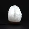 Glowing white Himalayan salt mountain lamp on a dark wooden base.