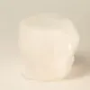 Raw white crystal tealight candle holder with natural rough-cut faceted edges.