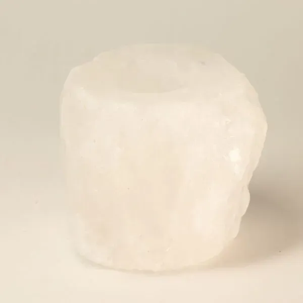 Raw white crystal tealight candle holder with natural rough-cut faceted edges.