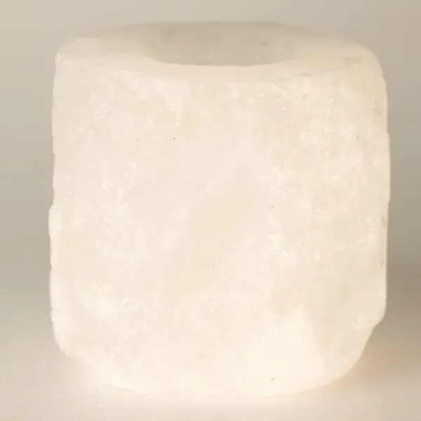 White cylindrical Himalayan rock salt tea light holder featuring a coarse, natural finish.