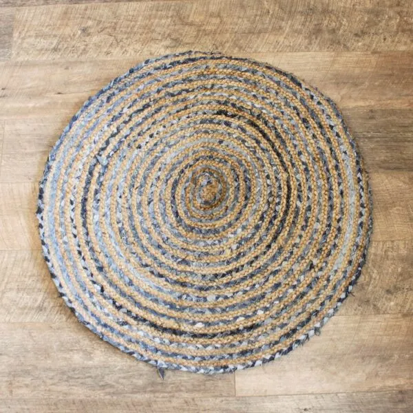 Round Braided Area Rug Jute and Denim Blue Spiral Pattern Handcrafted round braided jute and recycled denim area rug with a blue spiral pattern.
