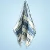 Blue and off-white striped Turkish cotton peshtemal towel with fringed edges.
