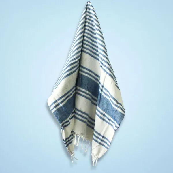 Blue and off-white striped Turkish cotton peshtemal towel with fringed edges.