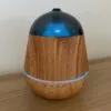 Essential Oil Diffuser Wood Grain Dark Blue LED Timer Wood grain essential oil diffuser with a dark blue dome and LED timer controls.