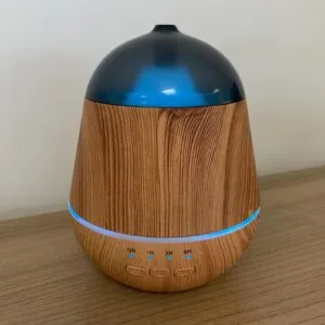 Essential Oil Diffuser Wood Grain Dark Blue LED Timer Wood grain essential oil diffuser with a dark blue dome and LED timer controls.