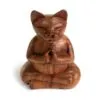 Hand-carved brown wooden cat figurine seated in a lotus meditation pose.