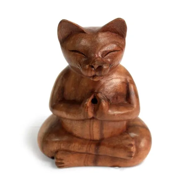 Hand-carved brown wooden cat figurine seated in a lotus meditation pose.
