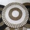 Circular Rug Braided Jute Beige and White Concentric Pattern Hand-woven circular braided jute rug with a beige and white concentric pattern.