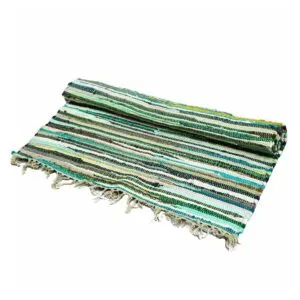 Partially rolled green striped rag rug with fringed edges, made from recycled fabric.
