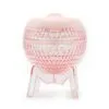 Faceted pink facial steamer and moisturiser on a clear M-shaped stand.