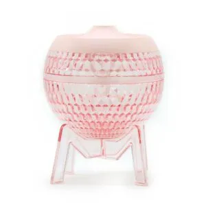 Faceted pink facial steamer and moisturiser on a clear M-shaped stand.
