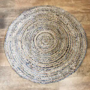 Round braided jute and blue denim rug with a concentric striped pattern.