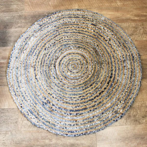 Round braided jute and blue denim rug with a concentric striped pattern.