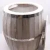 Rustic white-stained wooden barrel planter featuring riveted chrome metal bands.