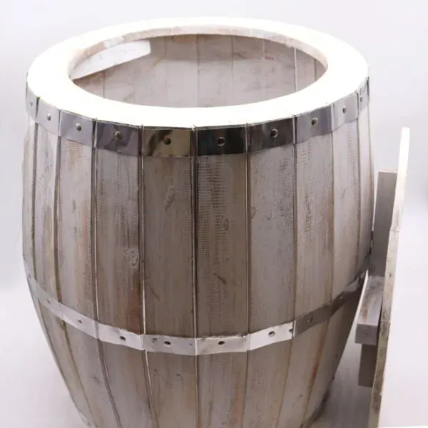 Rustic white-stained wooden barrel planter featuring riveted chrome metal bands.
