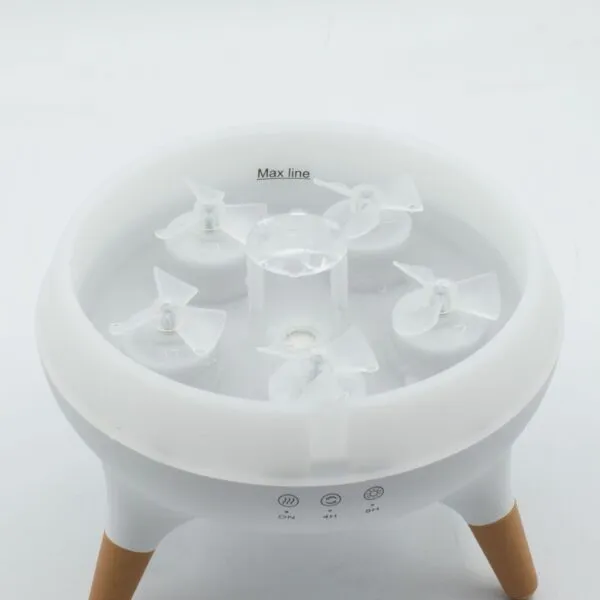 Essential Oil Diffuser Ultrasonic White - Wooden Legs Modern white ultrasonic essential oil diffuser featuring a clear reservoir and light wooden legs.